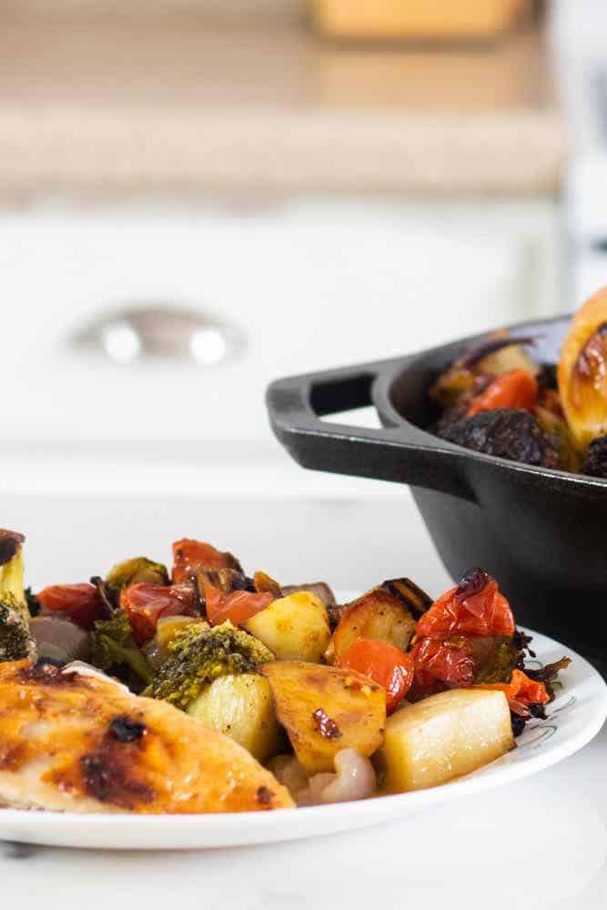 Savory plate of tuscan chicken and roasted vegetables.