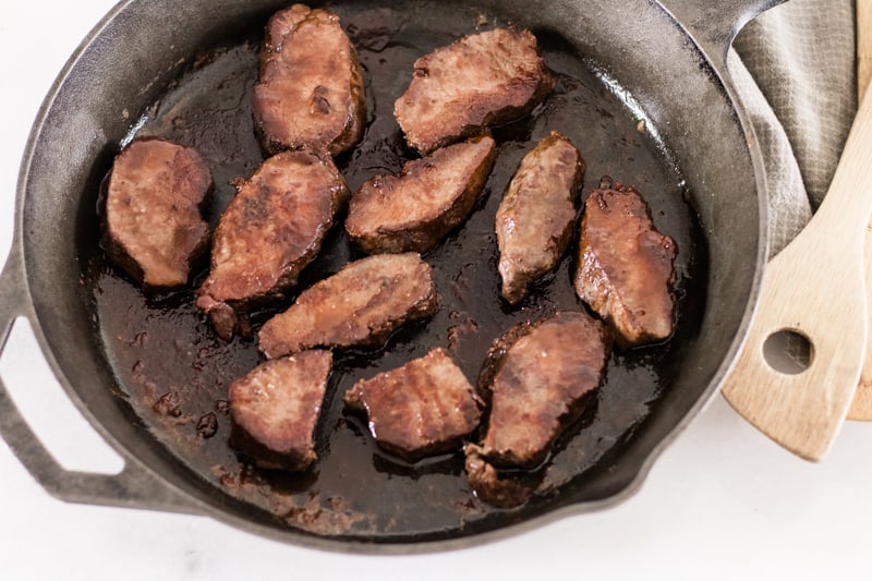 pan searing venison medallions in a cast iron skillet.