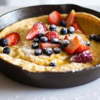 Dutch pancake with berries and maple syrup.