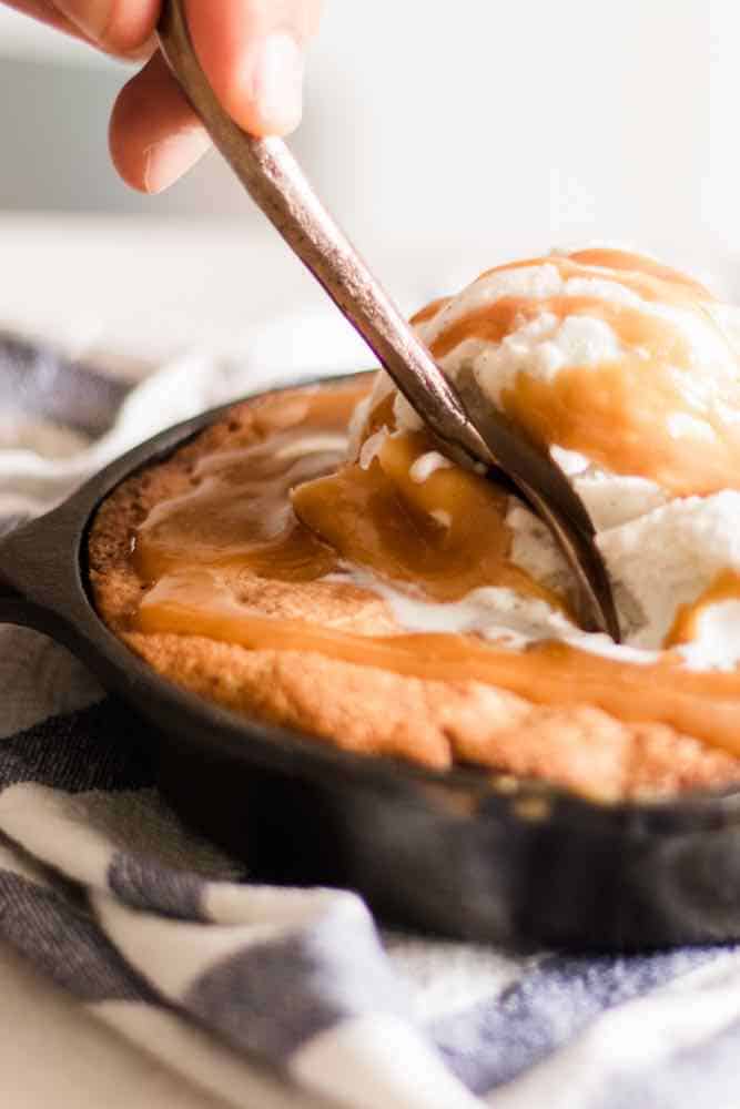 Taking a scoop out of a freshly baked homemade blondie.