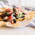 Cheesy Skillet taco on white plate with tortilla chips.