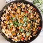 Mexican chicken skillet with beans greens and cheese.