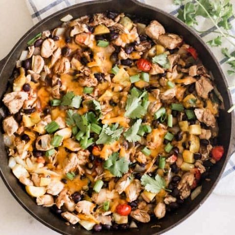 Mexican chicken skillet with beans greens and cheese.