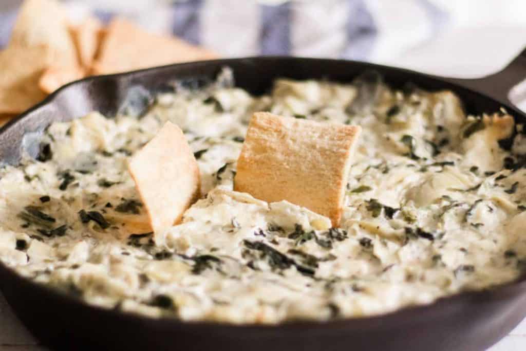 Spinach artichoke dip with pita chips.