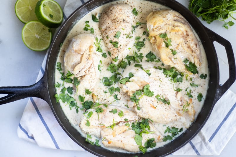 Smothered chicken in a cast iron skillet.