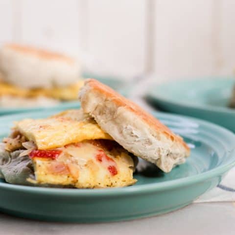 Homemade sourdough english muffin omelette on pewter plate.