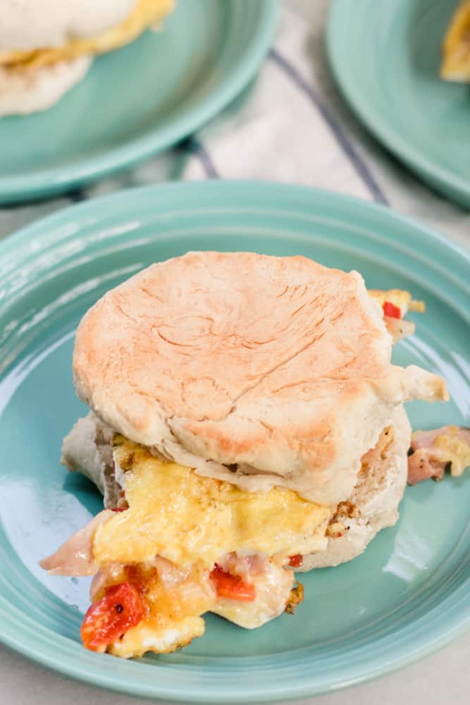 An omelet sandwich on light green plate.