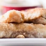 Homemade veggie egg rolls on white serving plate.