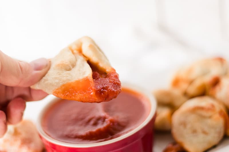 Homemade pizza roll with a scoop of marinara sauce.