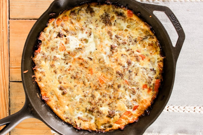 Cast iron breakfast casserole with potatoes, eggs, sausage and vegetables.