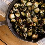 garlic parmesan roasted brussel sprouts in a cast iron skillet.