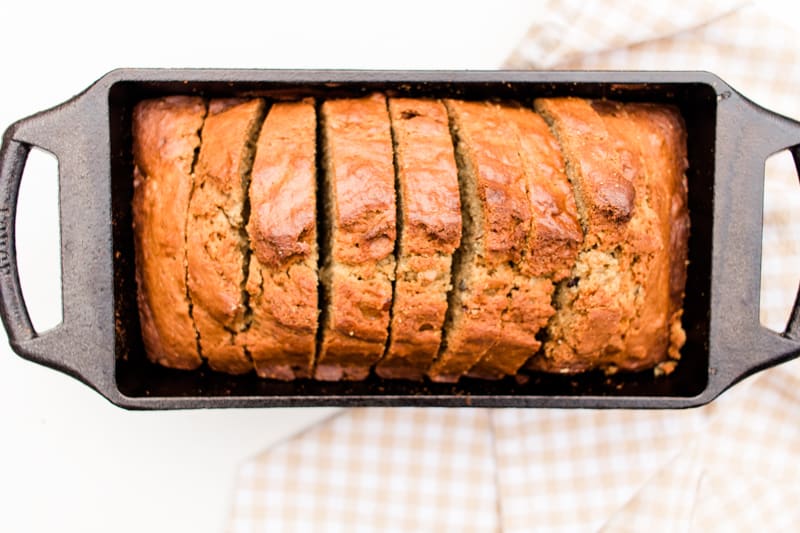 Banana bread with chocolate chips and walnuts in a cast iron lodge loaf pan.