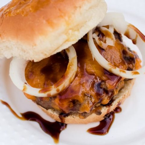 juicy venison burger with egg wash bun. Topped with onions and date sauce.
