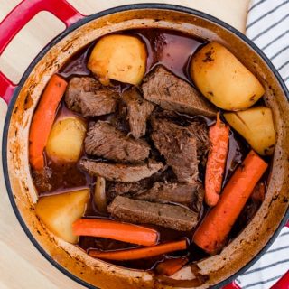 Venison sirloin tip roast with carrots and potatoes in a dutch oven.