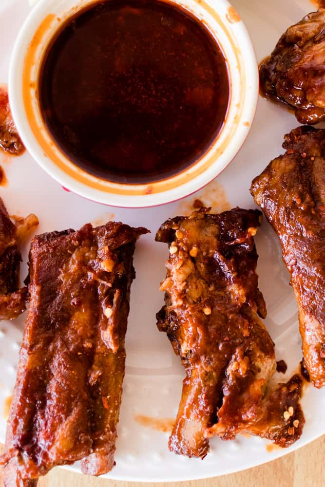 Spare ribs baked in the dutch oven on white plate.