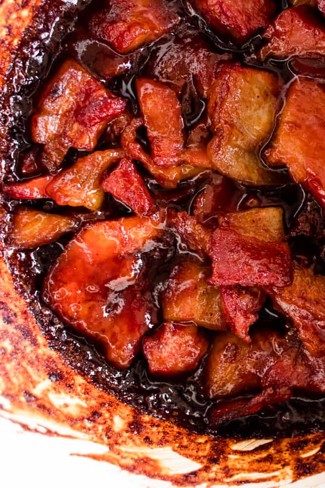 Oven baked bacon ends in a dutch oven.