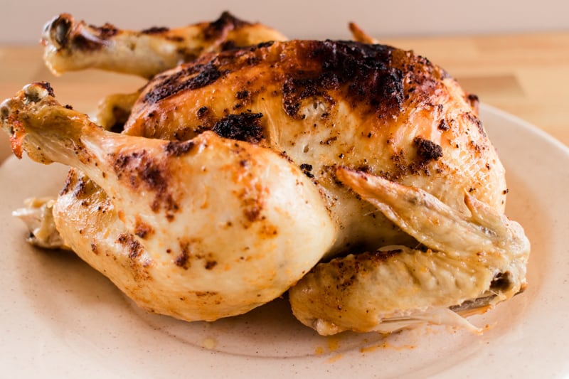 Dutch oven roast chicken on a serving platter.