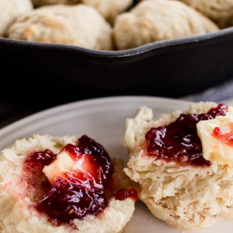 Homemade honey biscuits with butter and jam.
