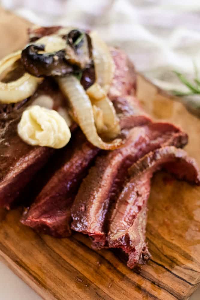 Perfectly seared beef heart with mushrooms and onions.