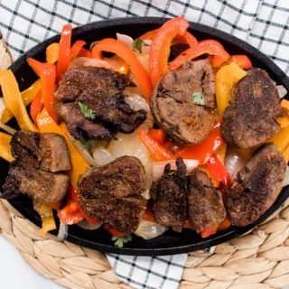 Sliced lengua with sauteed veggies for tacos.