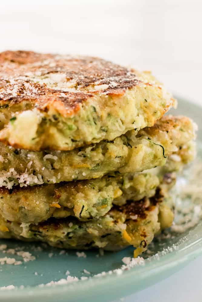 Stack of zucchini fritters drizzled with panko breadcrumbs.