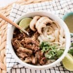Vietnamese oxtail pho recipe on a white marble table.