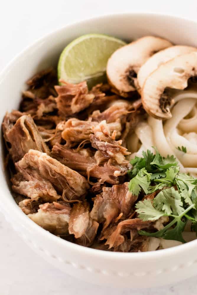 Beef oxtail pho with fresh cilantro and mushrooms slices.