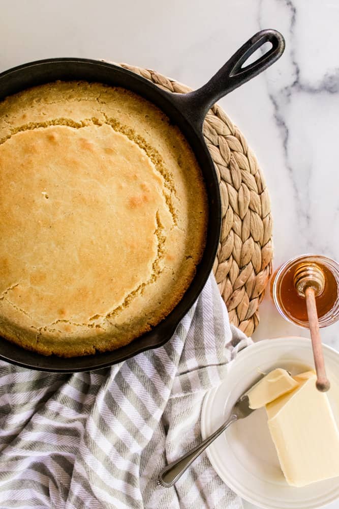 Homemade Corn meal bread in a large cast iron skillet.