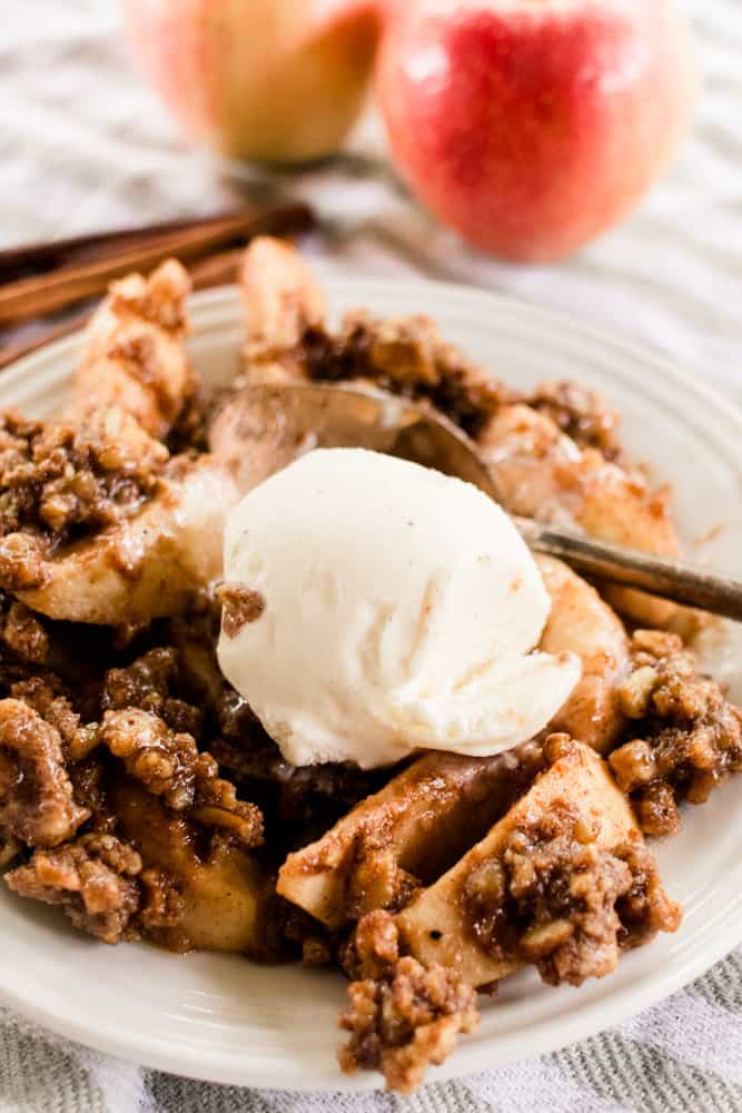 Hot apple crumble with a heaping scoop of vanilla bean ice cream.