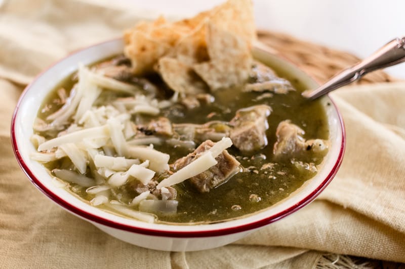 Green chili verde with cheddar cheese and tortilla chips.