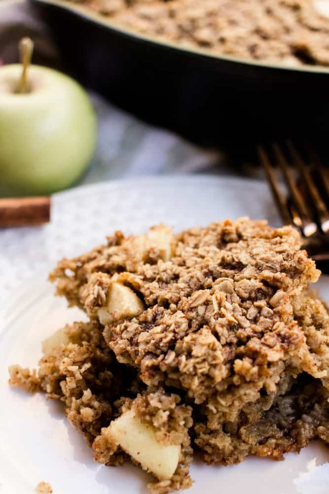 Apple cinnamon baked oatmeal on a white plate. 