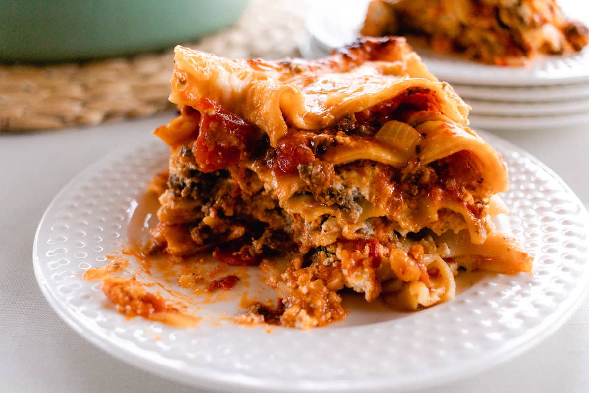 A generous helping of homemade lasagna with nice even layers of noodles, cheeses and meat.