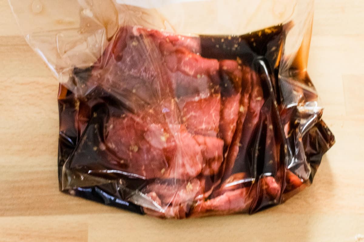 Marinading thin bottom round steaks in a ziplock bag.