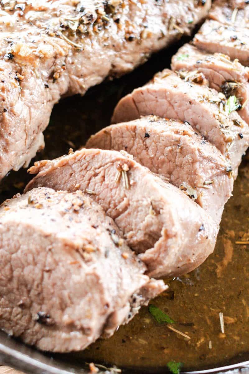 Juicy pork tenderloin in a cast iron skillet.