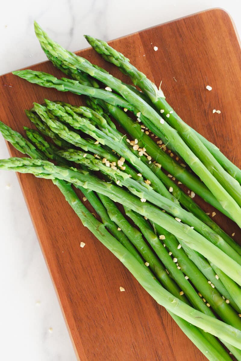 Seasoned asparagus spears after boiling in a dutch oven.