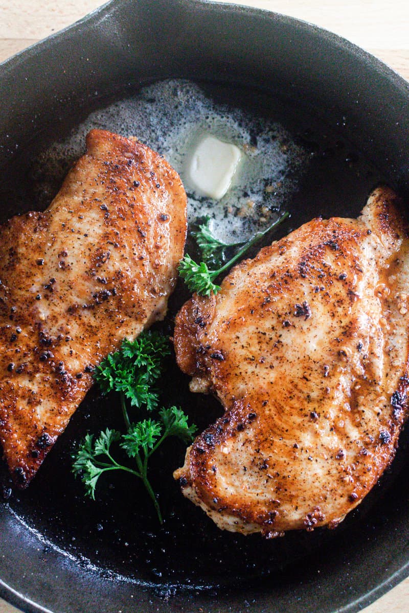 Cast iron chicken breast in a cast iron skillet.
