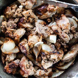 Chicken liver fried in a cast iron skillet with onions.