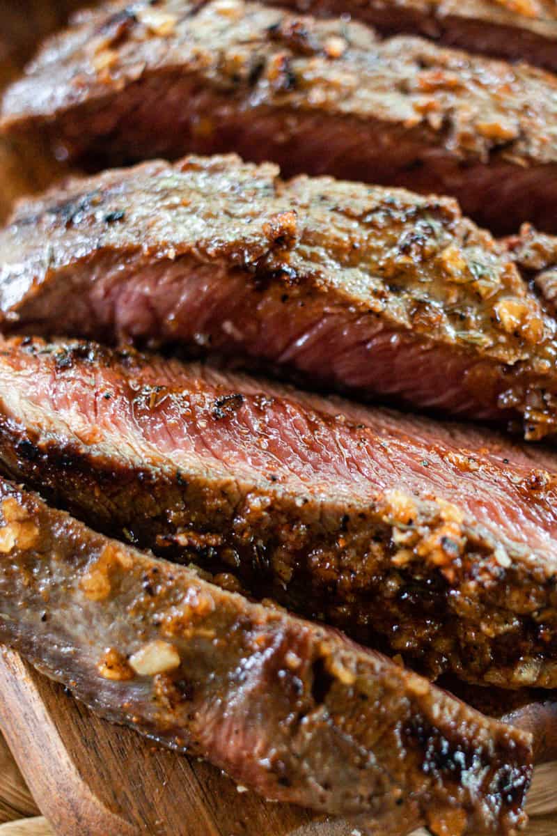 A close up of the seasoning on thinly sliced steak.