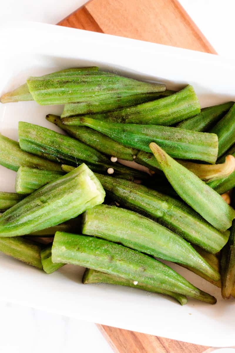 Displayed on a serving platter are freshly cooked boiled okra.