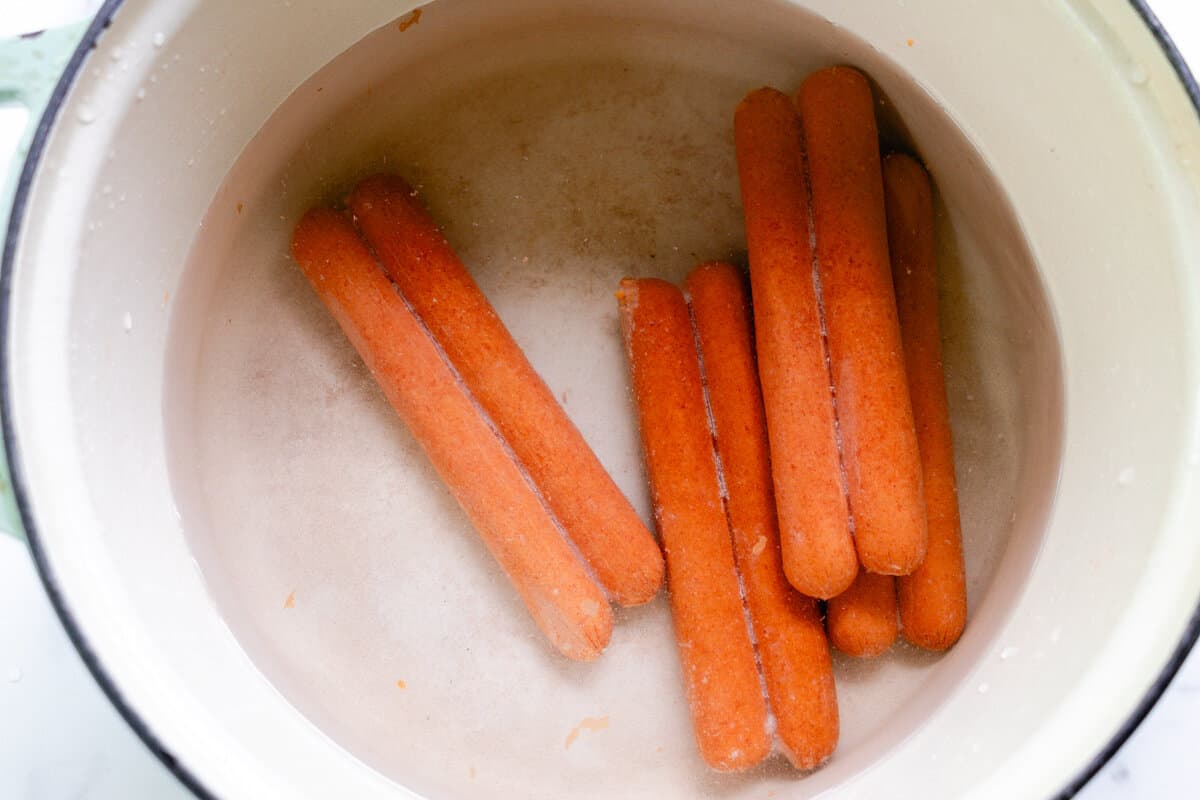 Frozen hot dogs thawing in a dutch oven. 