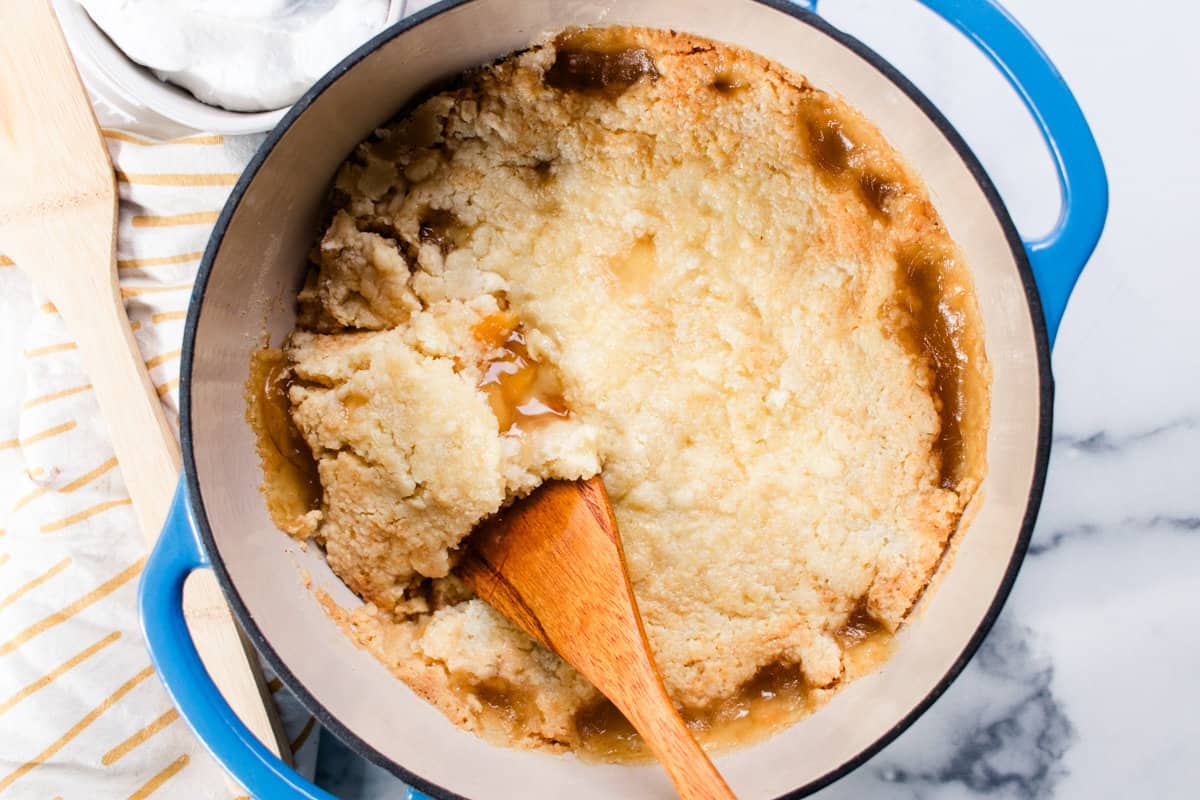 Fresh out of the oven, dump cake in a dutch oven with a wooden spoon ready for serving. 