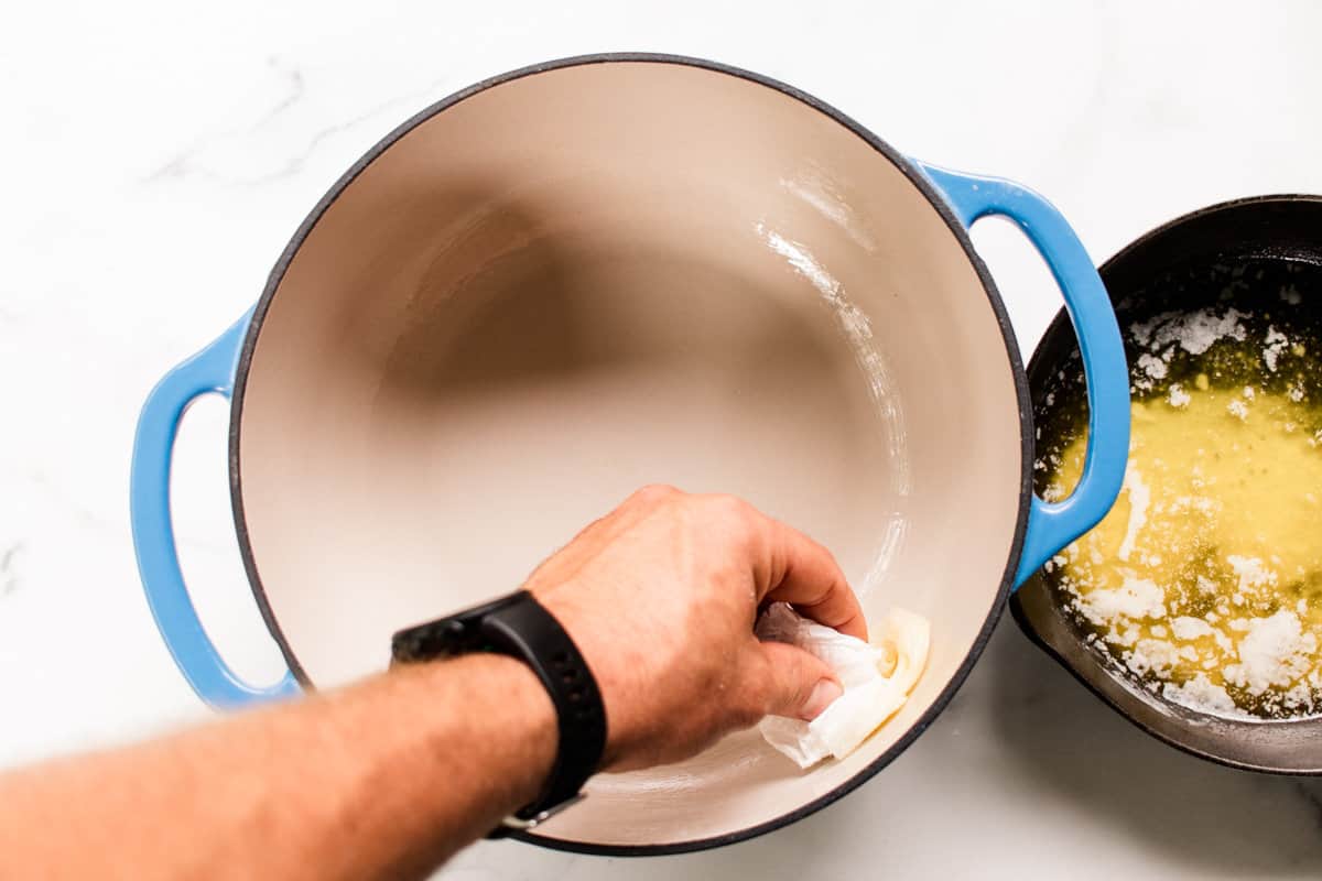 Gently coating the inside of a 4.5 qt dutch oven with a bit of the melted butter.