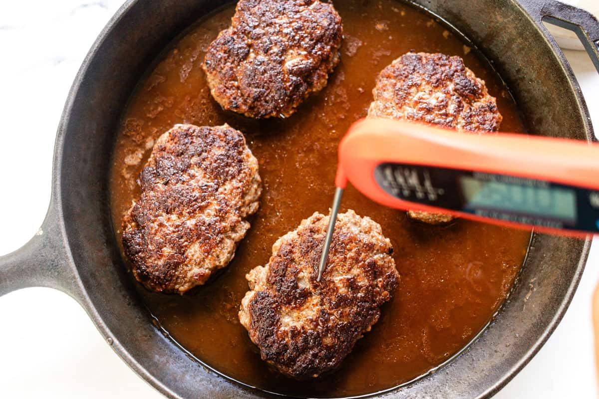 Finally, carefully place the steaks back into the skillet, cover with aluminum foil and simmer for 10 minutes until it reaches an internal temperature of 165°F.