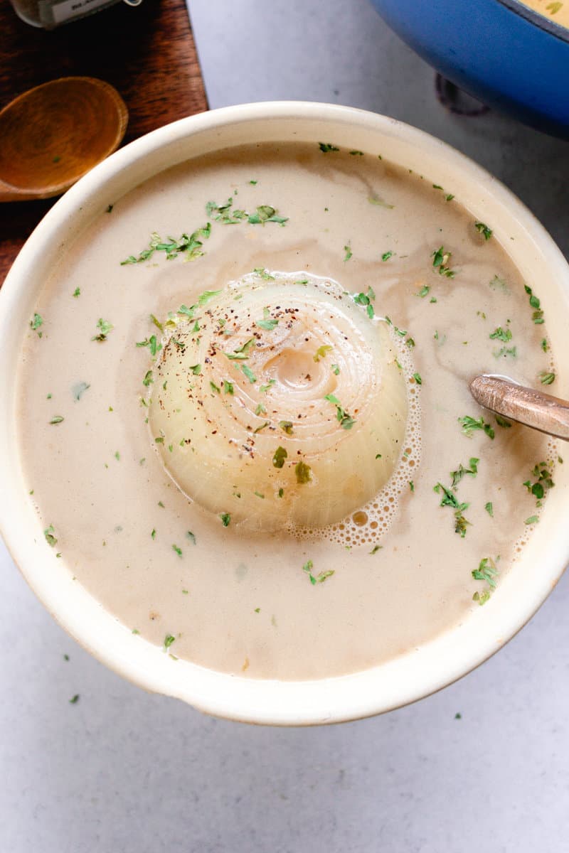 Enjoying a bite of boiled onion soup on a marble table.