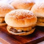 Thick, juicy moose burgers with sesame seed buns brushed with butter.