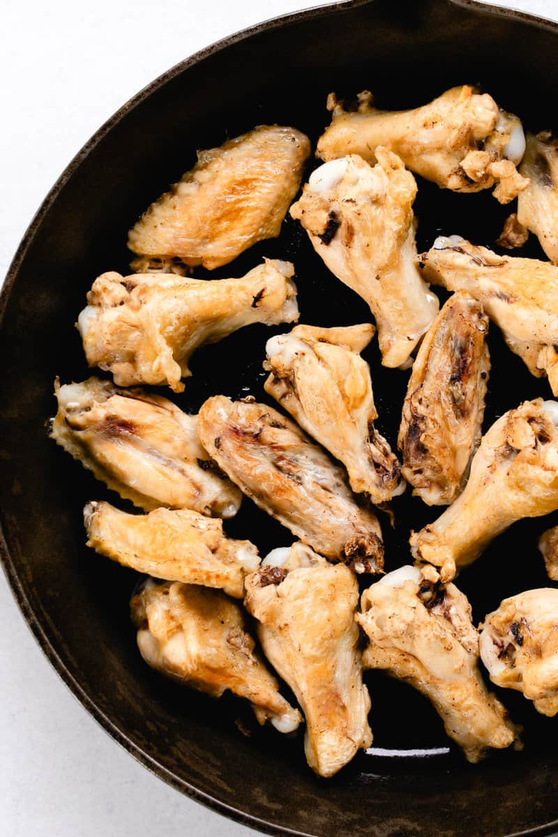 Fresh out of the oven are crispy wing in a skillet.