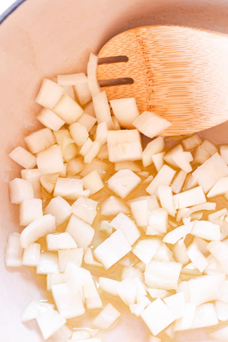 Sauteing onions in olive oil in a large pot. 