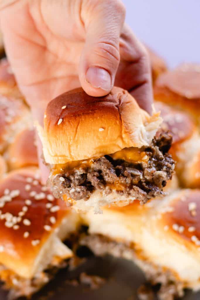 Holding up a venison slider with my hands.