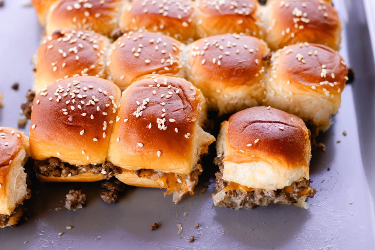 Fresh out the oven are cheesy venison sliders on a serving dish. 