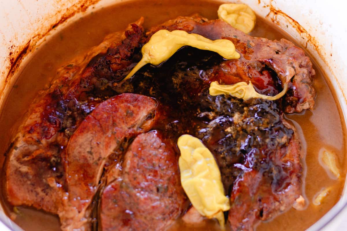 Mississippi pot roast cooking in a dutch oven.